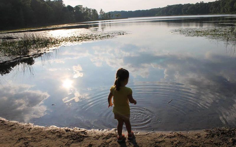 Asylum-Lake-Preserve girl throwing rocks in water