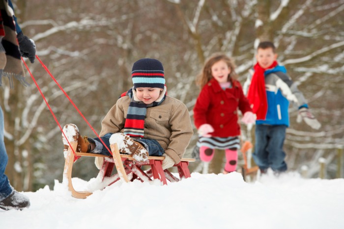 Kids sledding in the snow - Kalamazoo Winter Fun Guide Outdoor