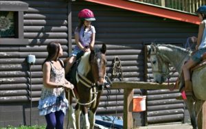 Kids riding horses lessons