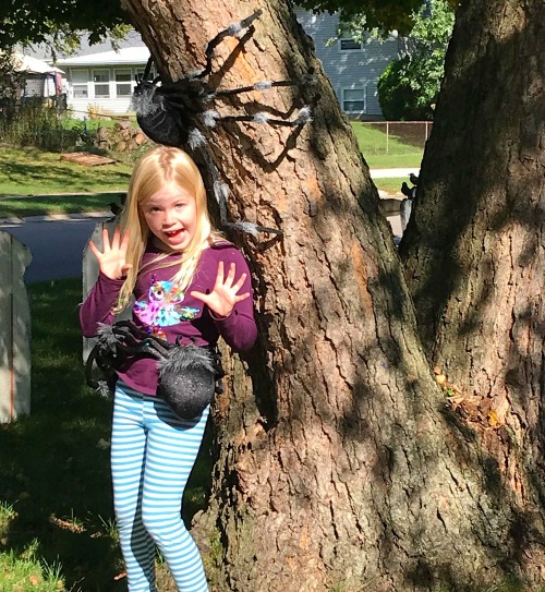 girl next to spooky spider display Kalamazoo