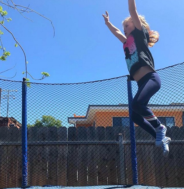 Girl Jumping on Trampoline - at home