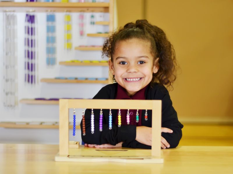 Battle Creek Montessori Academy girl with math tool
