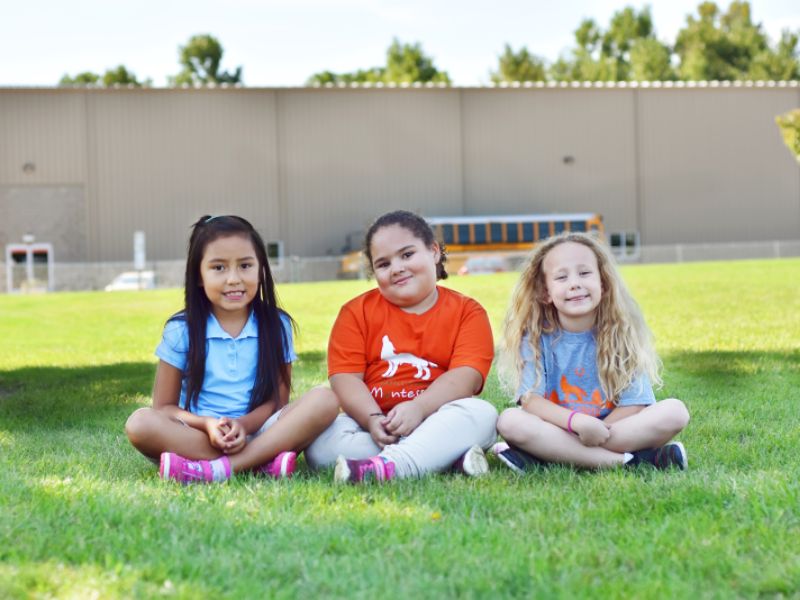 Battle Creek Montessori Academy girls sitting outside school