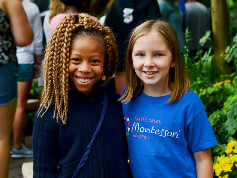 Battle Creek Montessori Academy girls smile at camera